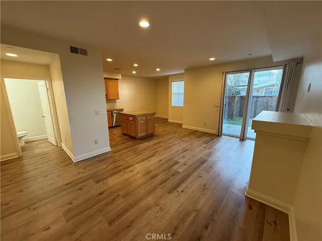 a kitchen with stainless steel appliances granite countertop a sink stove refrigerator and microwave