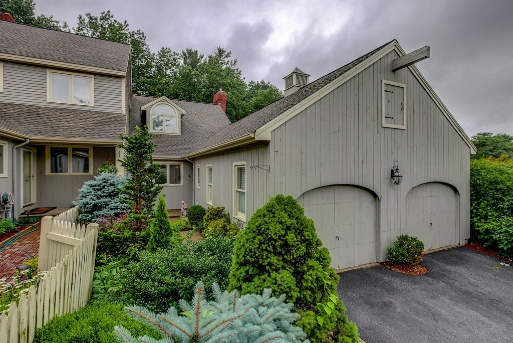 13 Wynridge Road, Unit 13 Windham, NH 03087 - Photo 1 of 29 a front view of a house with garden