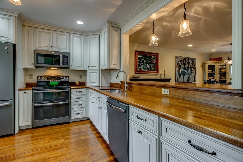 13 Wynridge Road, Unit 13 Windham, NH 03087 - Photo 5 of 29 a large kitchen with stainless steel appliances granite countertop a stove and a sink