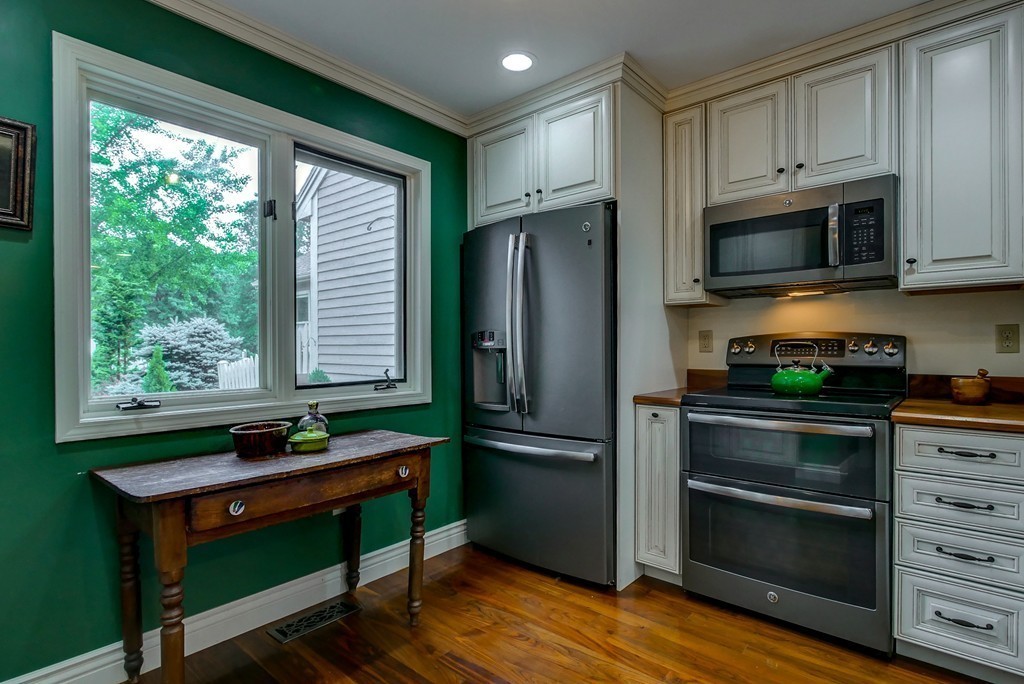 13 Wynridge Road, Unit 13 Windham, NH 03087 - Photo 6 of 29 a kitchen with stainless steel appliances a stove microwave and refrigerator