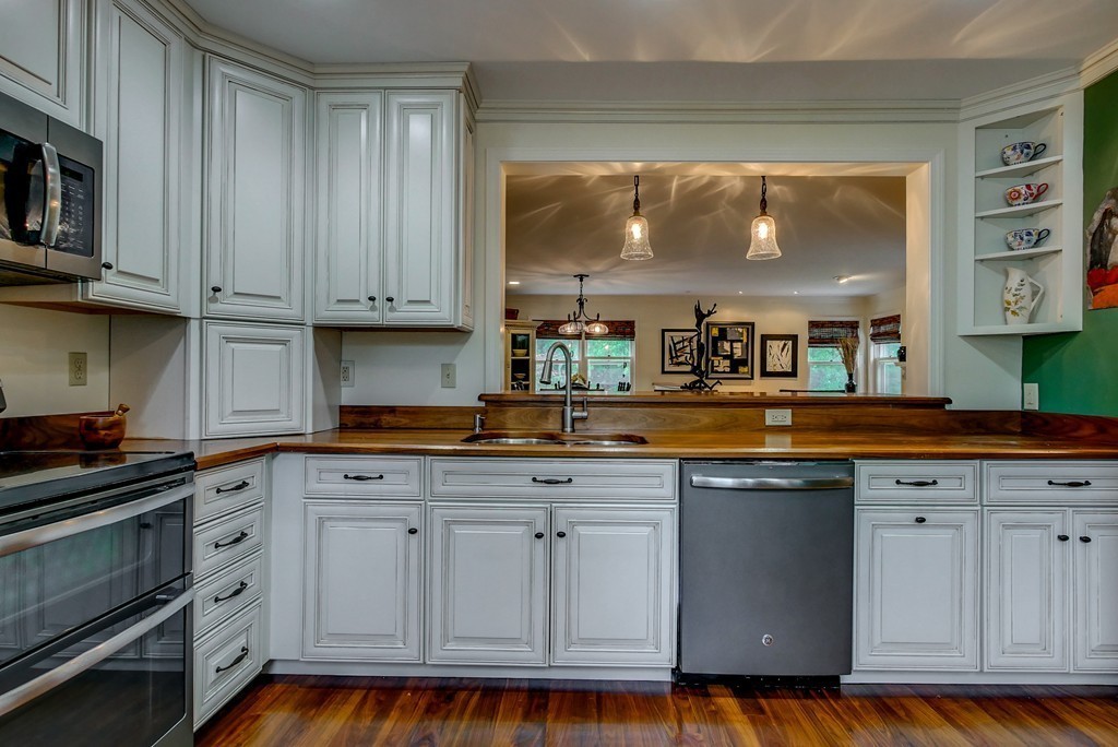13 Wynridge Road, Unit 13 Windham, NH 03087 - Photo 7 of 29 a kitchen with white cabinets and sink