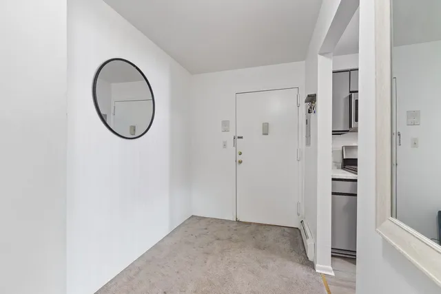 a view of a livingroom with wooden floor and white walls