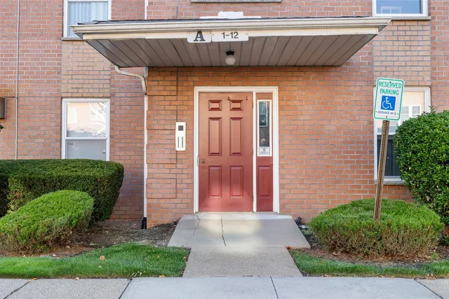 a front view of a house with a garden and plants