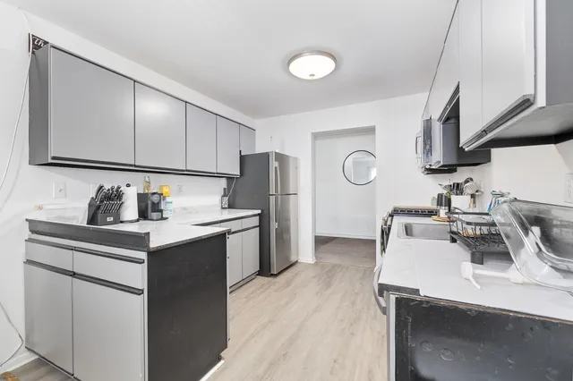 a kitchen with a sink cabinets and appliances