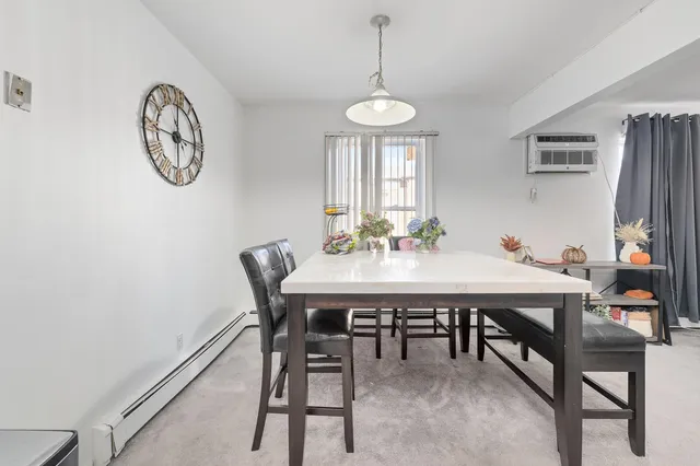 a view of a dining room with furniture and a chandelier