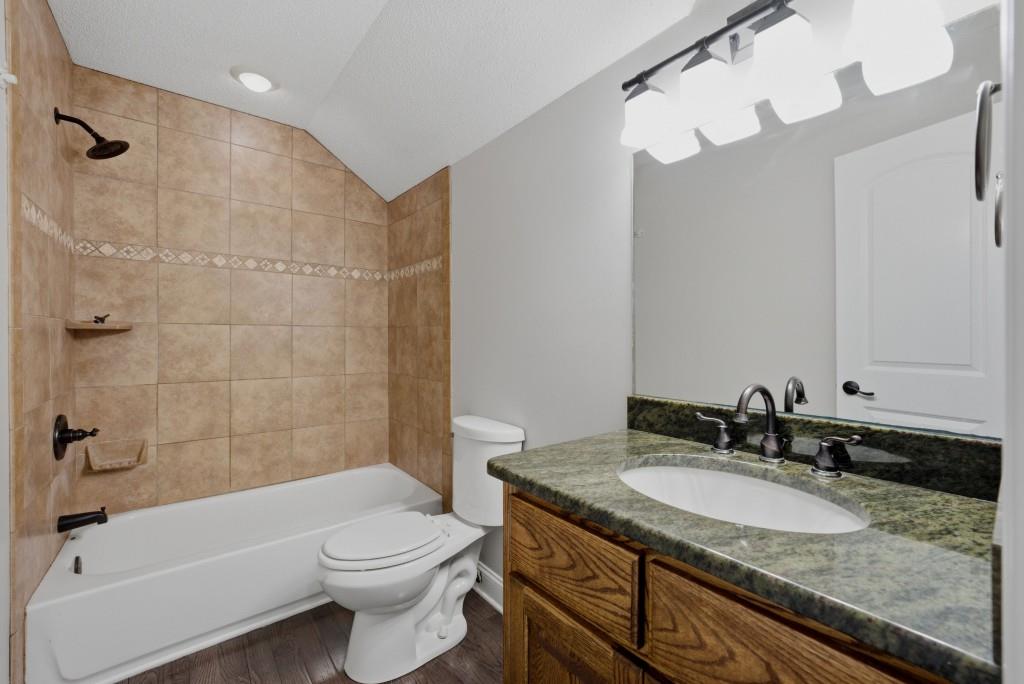 582 Knox Chapel Road Social Circle, GA 30025 - Photo 30 of 49 a bathroom with a granite countertop sink a toilet and bathtub