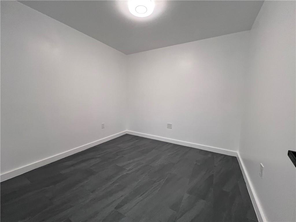 7855 Roswell Road Atlanta, GA 30350 - Photo 13 of 24 a view of an empty room with wooden floor