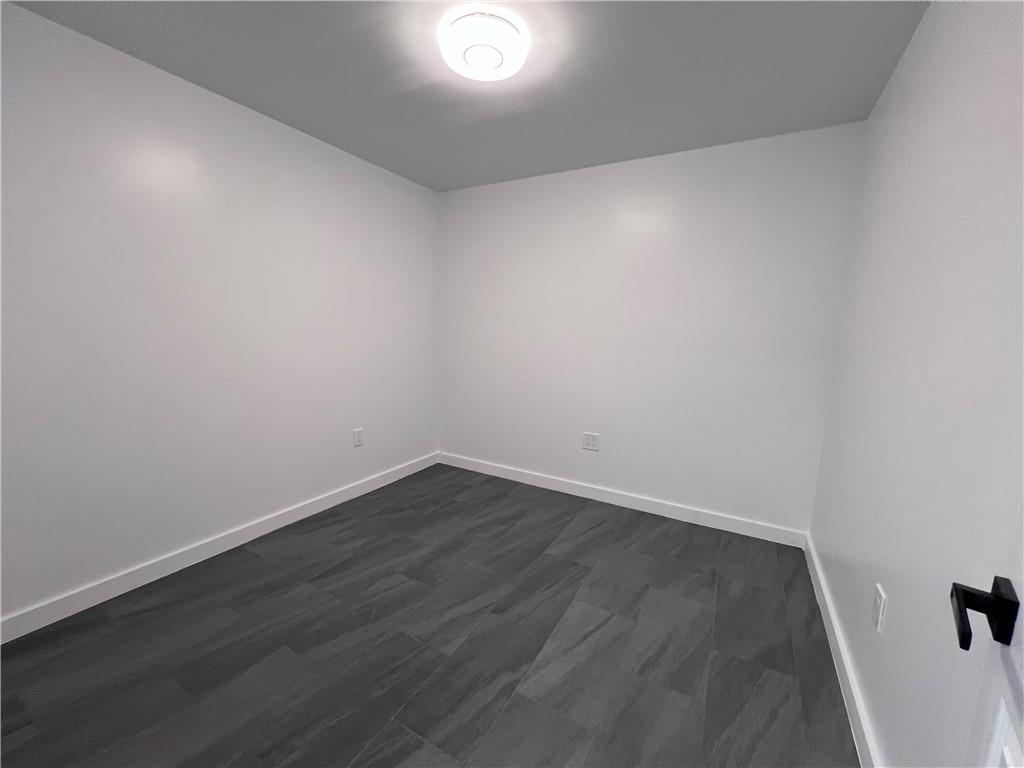 7855 Roswell Road Atlanta, GA 30350 - Photo 14 of 24 a view of an empty room with wooden floor