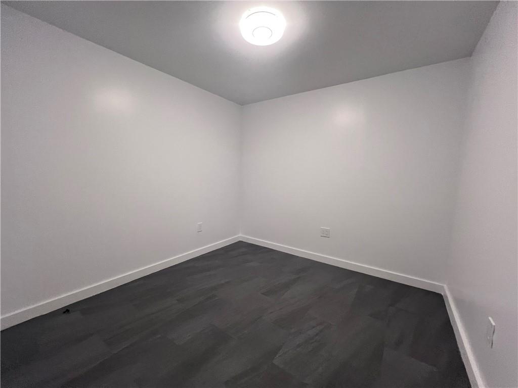 7855 Roswell Road Atlanta, GA 30350 - Photo 16 of 24 an empty room with wooden floor and windows