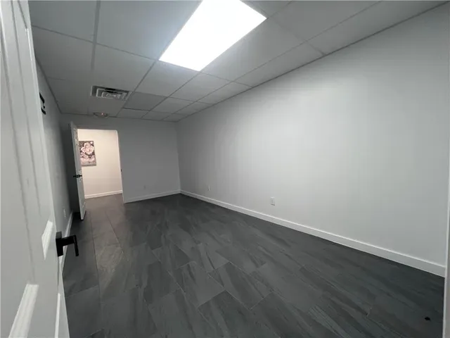 a view of a room with wooden floor and fan