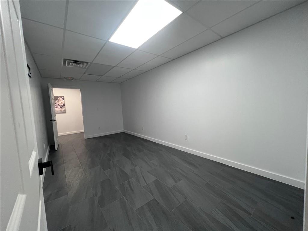 7855 Roswell Road Atlanta, GA 30350 - Photo 20 of 24 an empty room with wooden floor and windows