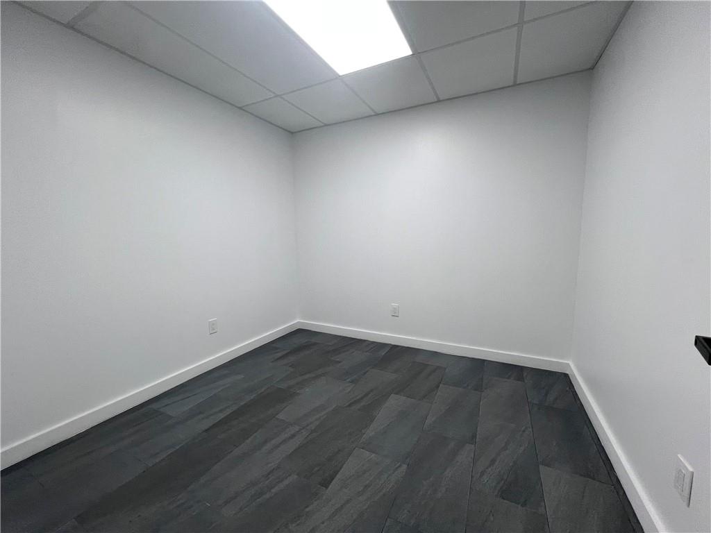 7855 Roswell Road Atlanta, GA 30350 - Photo 22 of 24 an empty room with wooden floor and windows