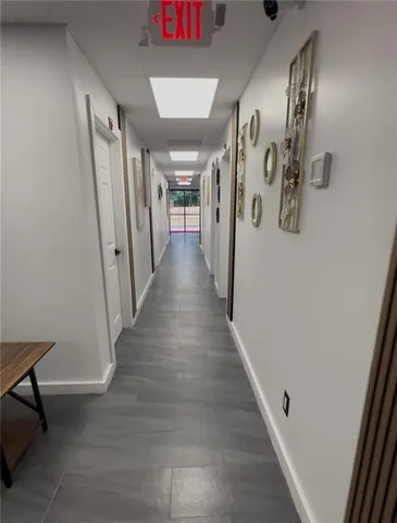 a view of a hallway with wooden floor and stairs