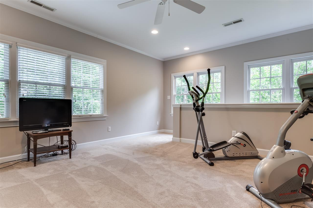 9428 Macon Road Raleigh, NC 27613 - Photo 17 of 25 Back stairs to finished bonus room features new carpet and lots of natural light. Bonus Room