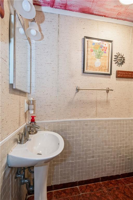 358 74th Street Brooklyn, NY 11209 - Photo 11 of 41 a bathroom with a sink and a mirror