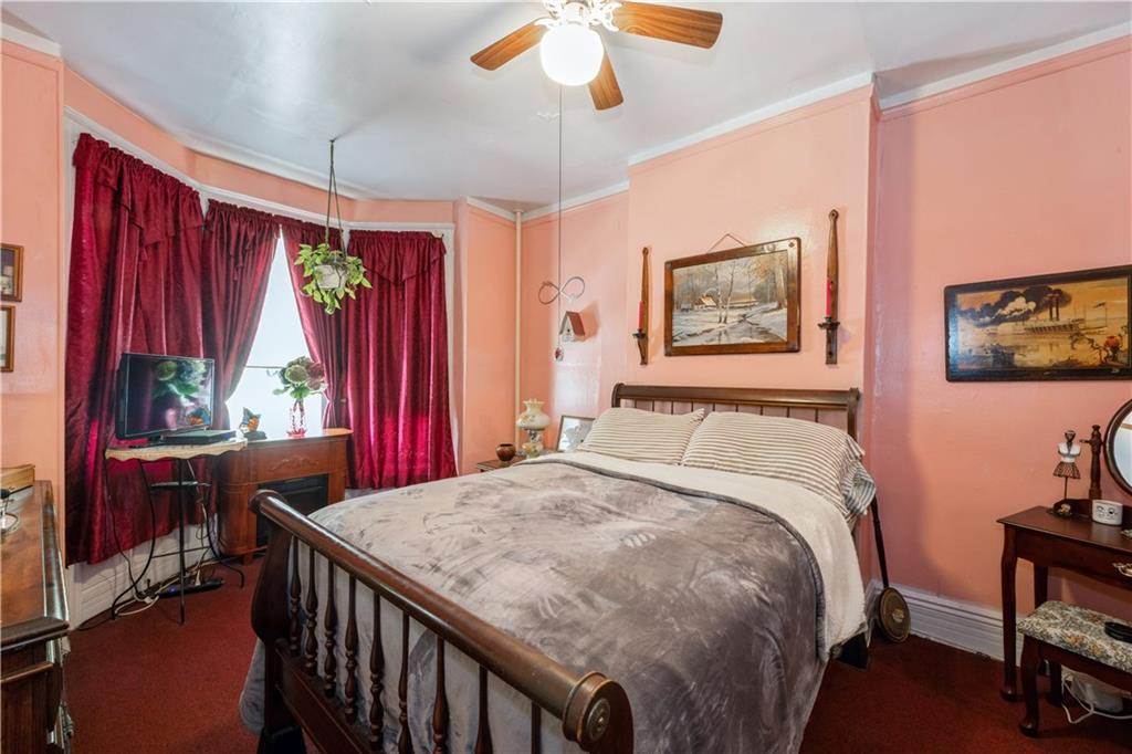 358 74th Street Brooklyn, NY 11209 - Photo 22 of 41 a bed sitting in a bedroom next to a window