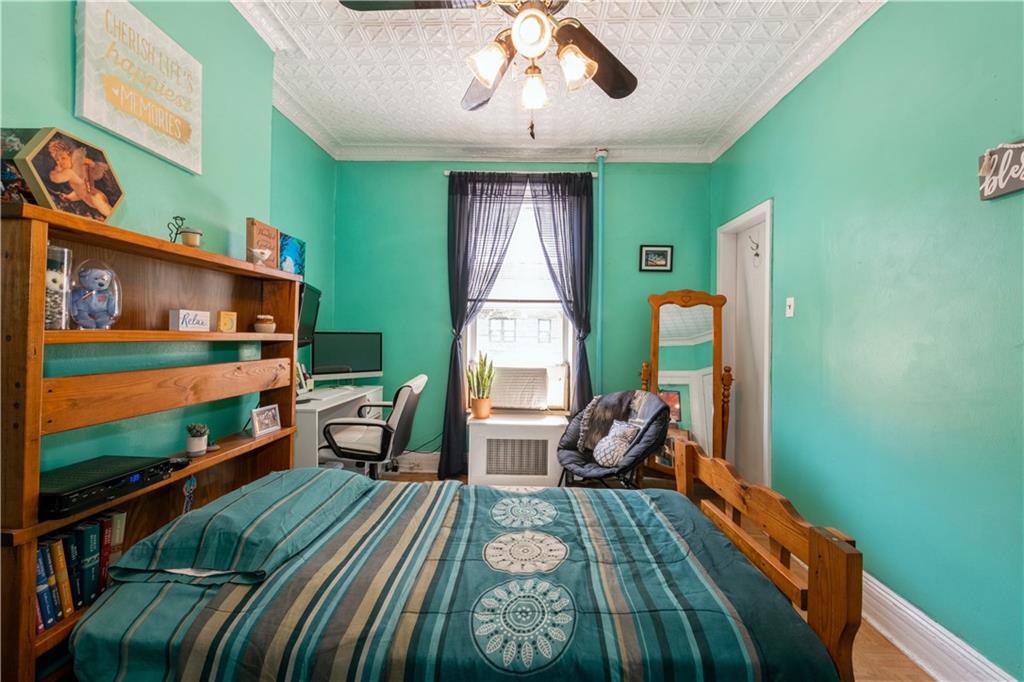 358 74th Street Brooklyn, NY 11209 - Photo 25 of 41 a bedroom with a bed and large windows