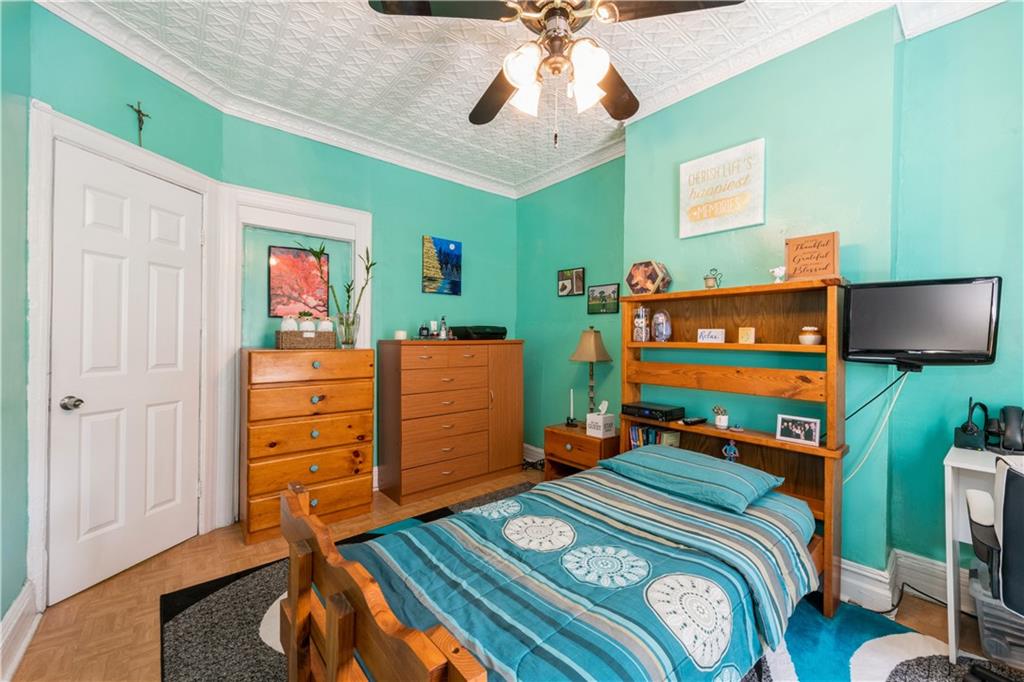 358 74th Street Brooklyn, NY 11209 - Photo 26 of 41 a bedroom with a bed and wooden floor