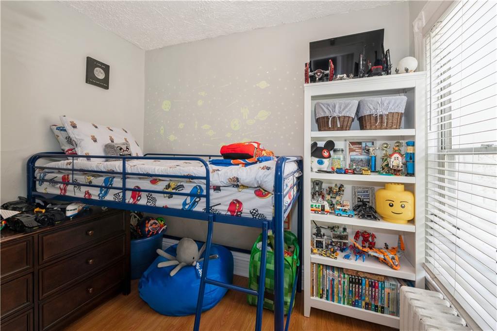 358 74th Street Brooklyn, NY 11209 - Photo 29 of 41 a room with lots of books and knick knacks on it