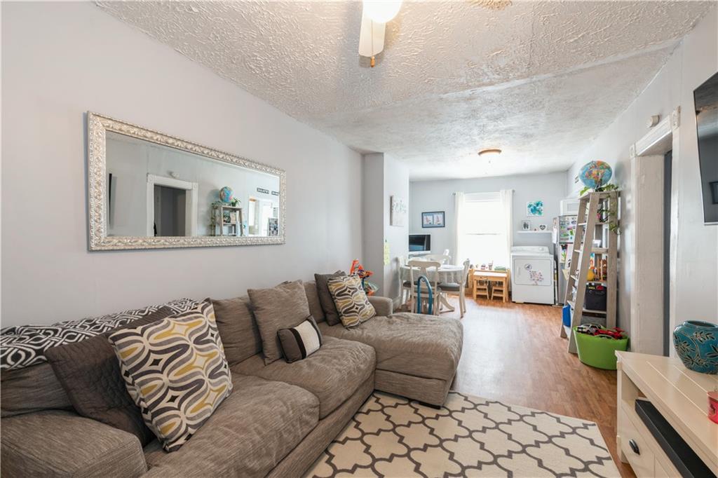 358 74th Street Brooklyn, NY 11209 - Photo 32 of 41 a living room with furniture and a couch