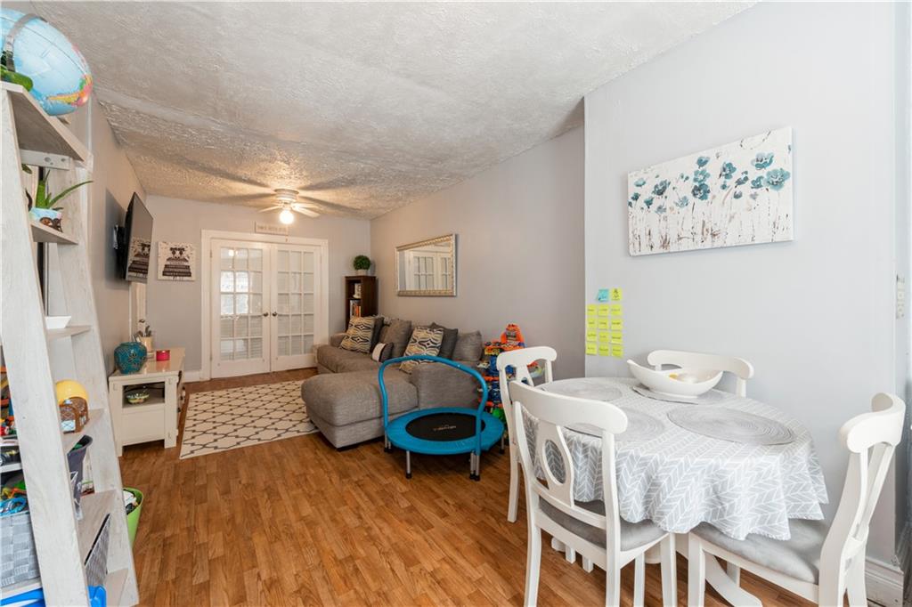 358 74th Street Brooklyn, NY 11209 - Photo 33 of 41 a living room with furniture and wooden floor
