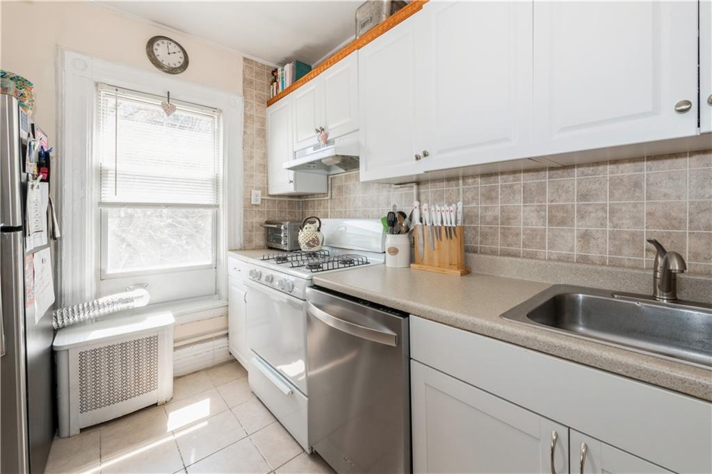 358 74th Street Brooklyn, NY 11209 - Photo 35 of 41 a kitchen with a sink appliances and cabinets