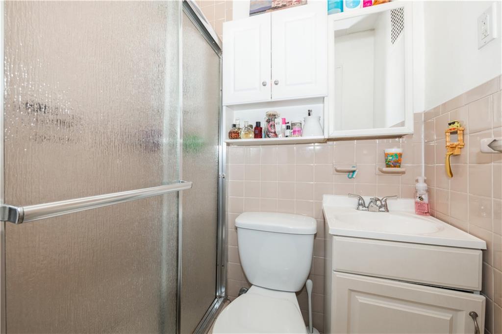 358 74th Street Brooklyn, NY 11209 - Photo 36 of 41 a bathroom with a toilet sink and vanity