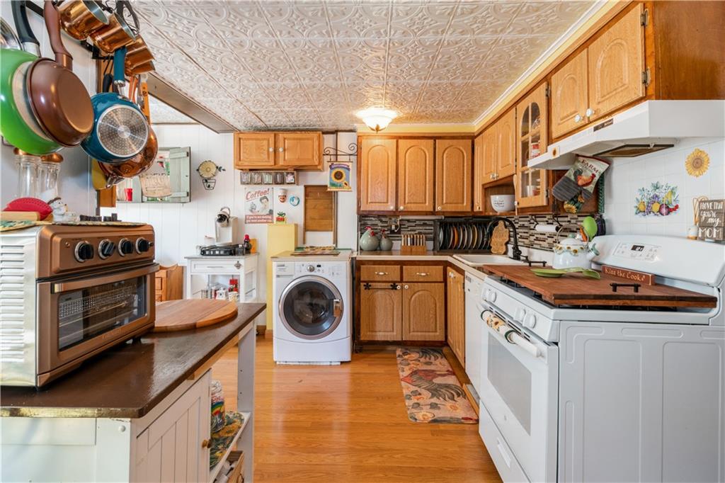 358 74th Street Brooklyn, NY 11209 - Photo 5 of 41 a kitchen with a stove a sink and cabinets