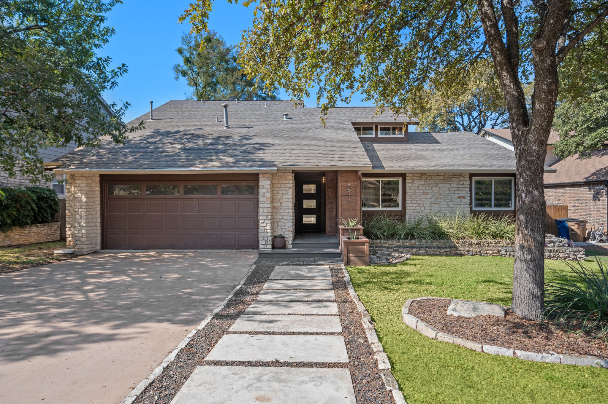 4614 Yellow Rose Trail Austin, TX 78749 - Photo 1 of 1 a front view of a house with a garden and yard