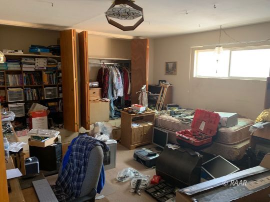 1302 South Mahan Street Ridgecrest, CA 93555 - Photo 11 of 17 a work room with furniture a bookshelf and a window