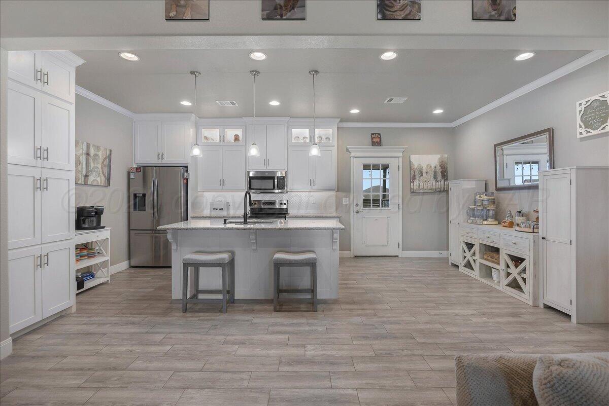 39 Cm Lane Canyon, TX 79015 - Photo 3 of 26 a open kitchen with white cabinets and stainless steel appliances