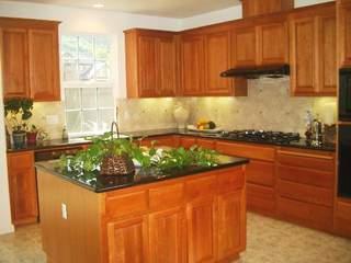 49 Hollyleaf Way Novato, CA 94949 - Photo 5 of 6 a kitchen with stainless steel appliances granite countertop a refrigerator and a stove