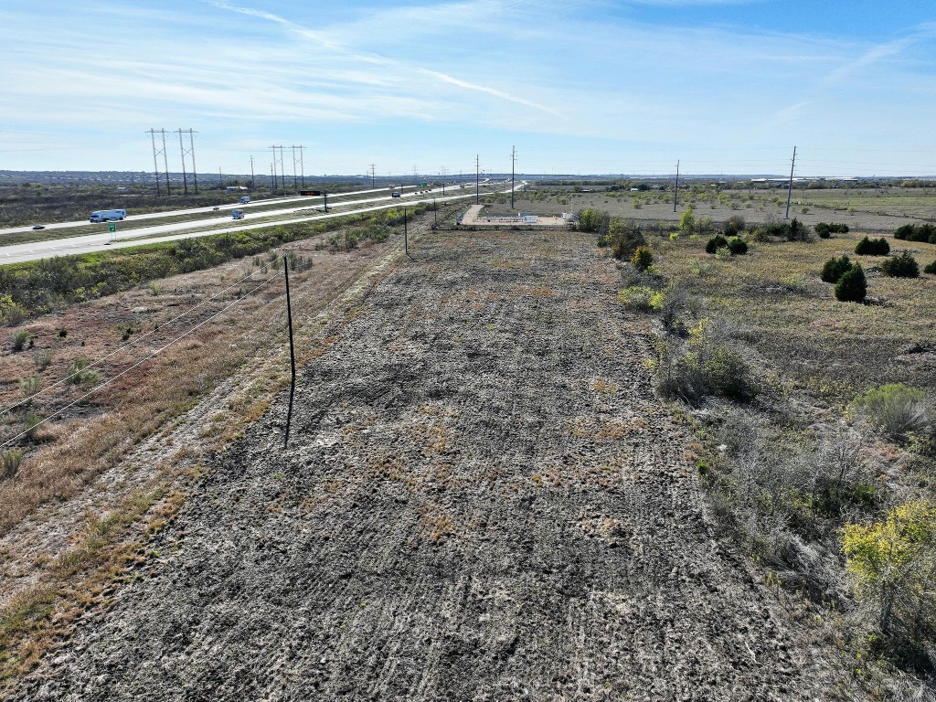 Tbd Tbd Tx-130 Austin, TX 78719 - Photo 10 of 10 a view of a dry yard with wooden fence