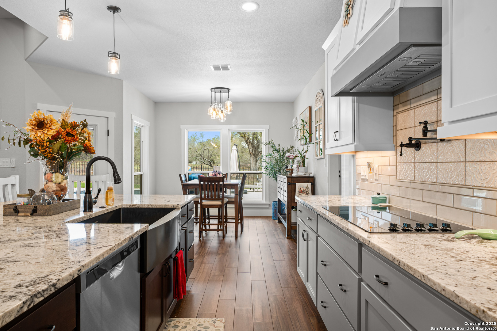 104 Archer Ridge Drive La Vernia, TX 78121 - Photo 15 of 45 a kitchen with granite countertop a sink stove and cabinets