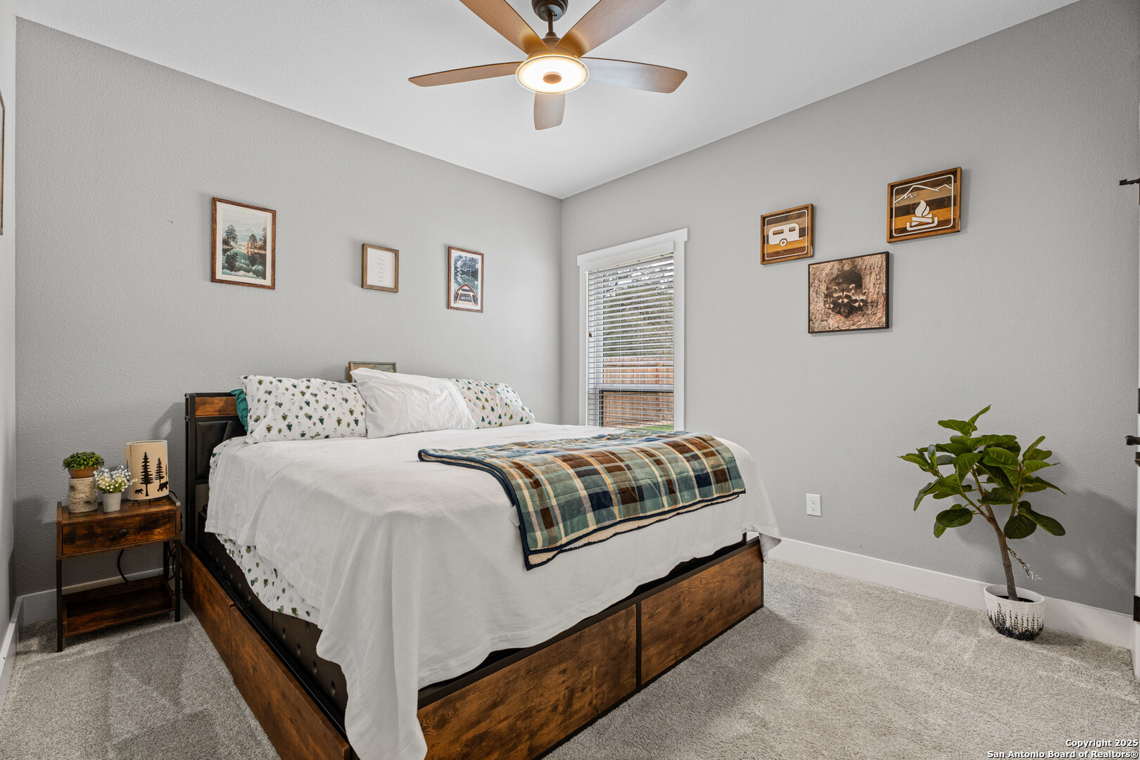 104 Archer Ridge Drive La Vernia, TX 78121 - Photo 26 of 45 a bedroom with a bed and a chandelier