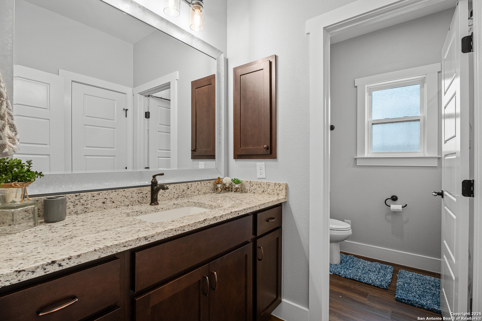 104 Archer Ridge Drive La Vernia, TX 78121 - Photo 27 of 45 a bathroom with a granite countertop sink and a mirror