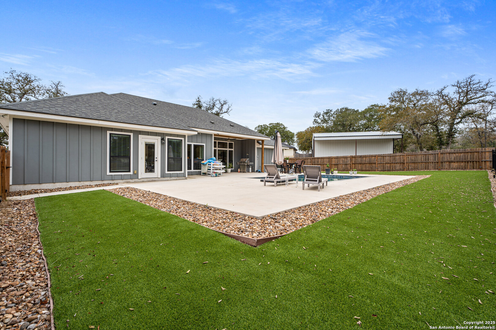 104 Archer Ridge Drive La Vernia, TX 78121 - Photo 32 of 45 a view of a house with a swimming pool and a yard