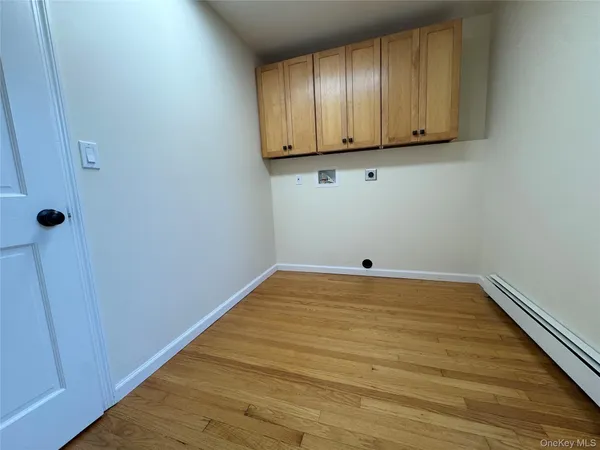 a kitchen with stainless steel appliances a sink cabinets and wooden floor