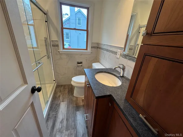 a view of a room with wooden floor and cabinet