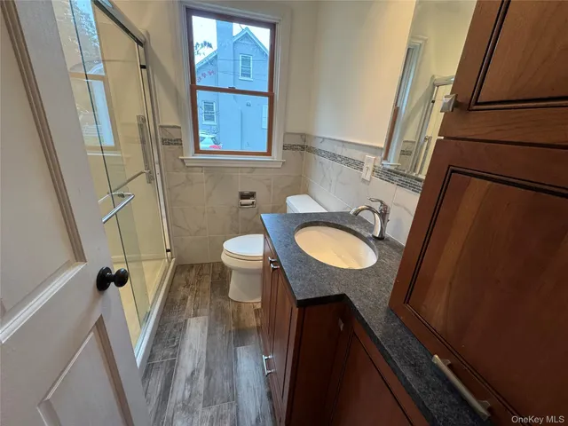 a view of a room with wooden floor and cabinet