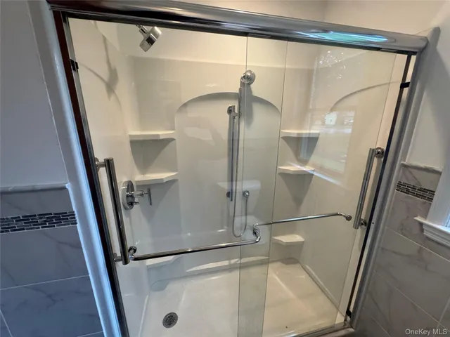 a view of a room with an empty space and wooden floor