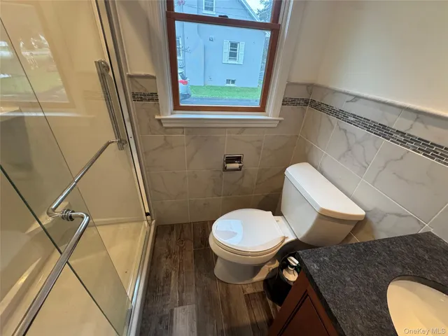 a bathroom with a sink a toilet a mirror and a tub