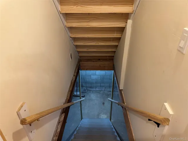 a view of a room with an empty space and wooden floor