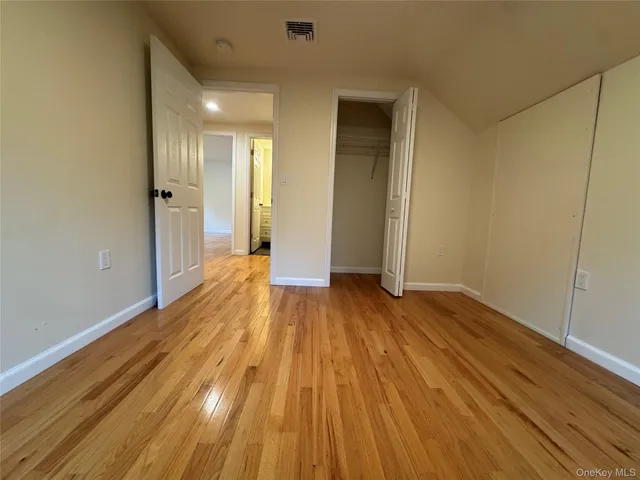 a view of a room with wooden floor and window