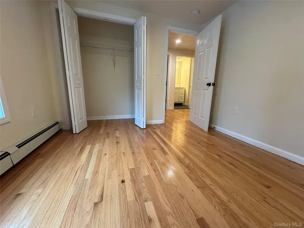 a view of a room with wooden floor and window