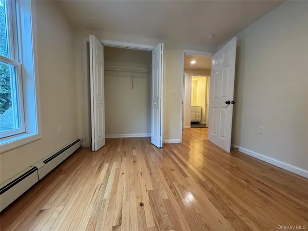 a view of a room with wooden floor and stairs