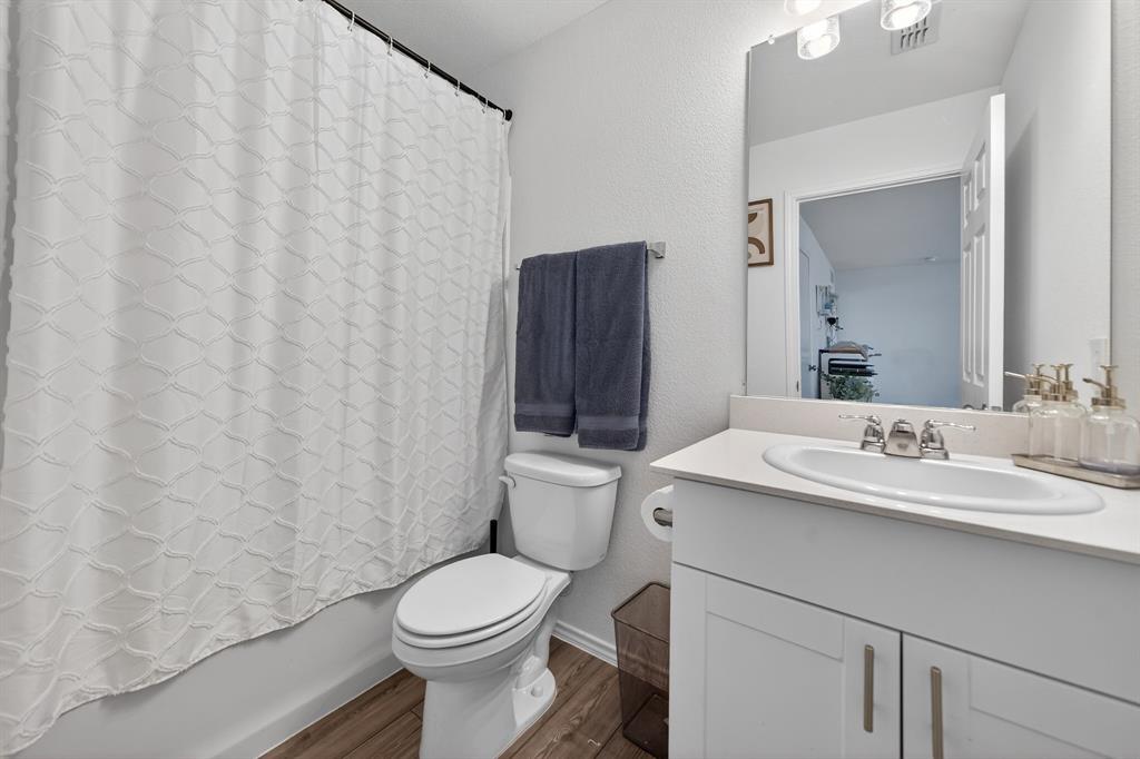 2081 Henrietta Drive Forney, TX 75126 - Photo 23 of 34 a bathroom with a sink a toilet and a mirror