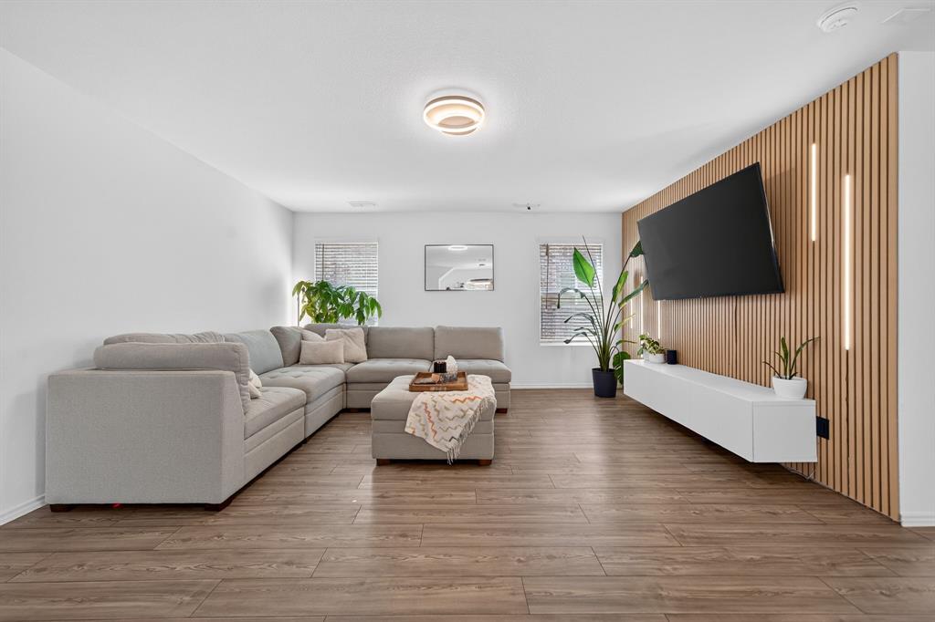 2081 Henrietta Drive Forney, TX 75126 - Photo 7 of 34 a living room with furniture and a flat screen tv