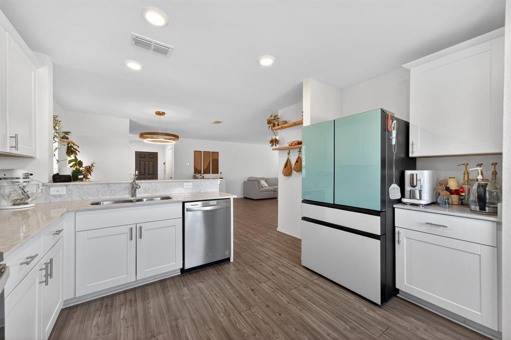 2081 Henrietta Drive Forney, TX 75126 - Photo 10 of 34 a kitchen with a sink cabinets and wooden floor