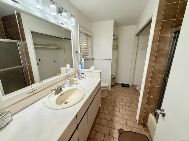 a bathroom with a sink double vanity and a mirror